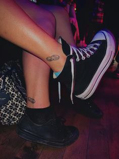 a woman's legs with tattoos on them