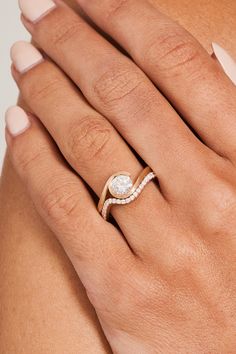 a woman's hand with a diamond ring on it