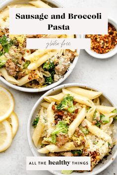 two bowls filled with pasta and broccoli on top of a white table next to lemon slices