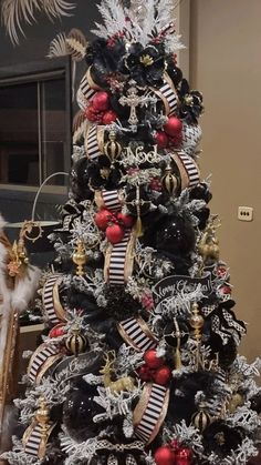 a christmas tree decorated with black and red ornaments