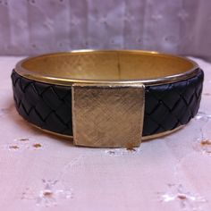 This beautiful piece is a Woven Black Leather and Goldtone Bangle Bracelet. No maker's mark found. Used but in great condition. Diameter of the bracelet is approximately 2 3/4 inches and height is approximately 3/4 inches. Not adjustable. Adjustable Stretch Bangle Bracelet For Formal Occasions, Adjustable Costume Jewelry Bracelets For Formal Events, Metal Stretch Bangle For Formal Occasions, Adjustable Formal Costume Jewelry Bracelets, Adjustable Band Bangle For Formal Occasions, Formal Metal Stretch Bangle, Formal Metal Costume Jewelry Bangle, Vintage Gold Leather Bracelet, Hand-strung Black Bangle Bracelet