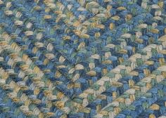 a close up view of a blue and green rug