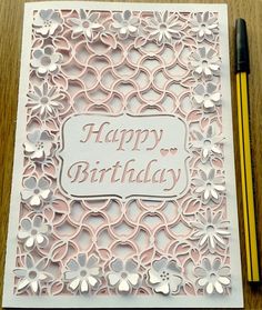 a card with the words happy birthday on it next to a pencil and some paper