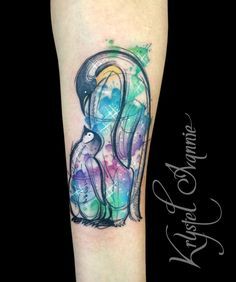 a colorful tattoo design on the leg of a woman's arm with an elephant and bird