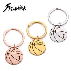 three basketball key chains with the number 1 and one ball on each side, in different colors