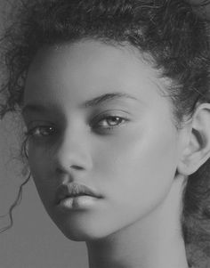 a black and white photo of a woman with curly hair