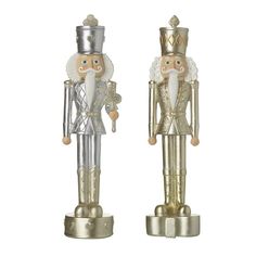 two gold and silver nutcrackers are standing side by side on white background