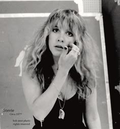 a black and white photo of a woman brushing her teeth