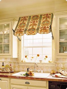 a kitchen window with sunflowers on the valance