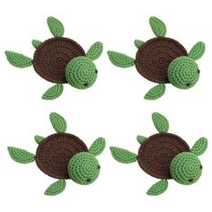 three crocheted sea turtles with green leaves on their backs and brown shelling