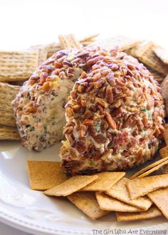 a white plate topped with crackers and cheese ball