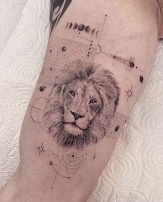 a man's leg with a lion tattoo on it, and stars in the background