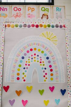 a bulletin board with hearts and a rainbow