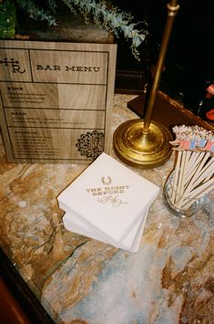 a table topped with candles and napkins next to a box filled with candy canes