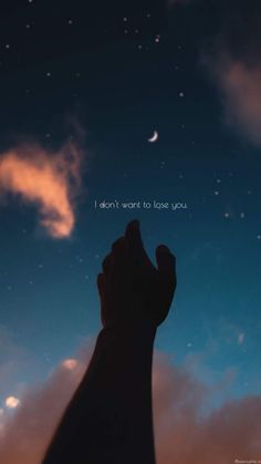 someone holding their hand up to the sky with stars and clouds in the background that says, i don't want to love you