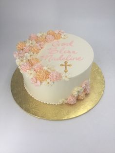 a white cake with pink and yellow flowers on it's side that says god has made me