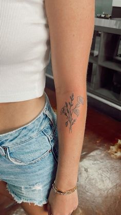 a woman with a flower tattoo on her arm