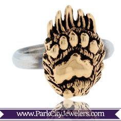 14K Yellow Gold Bear Paw on Sterling Silver Ring This unique 14K yellow gold bear paw on a sterling silver band represents the great tradition of the power and strength of the mighty bear. Hand carved by the Park City Jewelers, created with expert craftsmanship and detail. Dimensions: .70 in x .50 in SKU: P-231 Paw Ring, Wood Carving Faces, Claw Ring, Bear Claws, Bear Paw, Bear Paws, Inspired Jewelry, The Mighty, Sterling Silver Bands