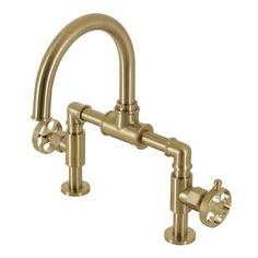 an antique brass faucet with two handles