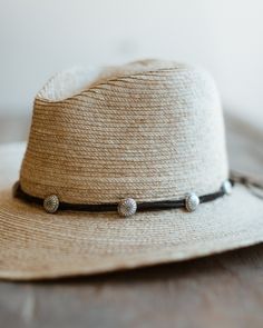 A new Crossbow favorite, brand new for spring 2024. Made with sterling silver sunflower concho buttons thread over genuine deerskin leather. Double wraps around hat and can just be tied for closure. Concho measures 5/8" in size. 8 conchos per band. Handmade by Crossbow in the mountains of Telluride, CO Adjustable Concho Hat For Festivals, Bohemian Concho Hat Bands Adjustable, Bohemian Adjustable Concho Hat Bands, Adjustable Bohemian Concho Hat Bands, Adjustable Western Hat With Concho, Adjustable Southwestern Concho Hat, Southwestern Adjustable Concho Hat, Western Adjustable Concho Hat, Southwestern Adjustable Hat Band With Concho