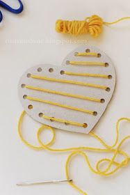 a heart shaped craft kit with yarn and scissors