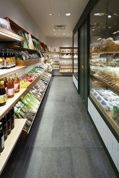 an empty grocery store filled with lots of food and drink bottles on the shelves next to each other