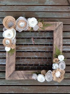 a wooden frame decorated with paper flowers