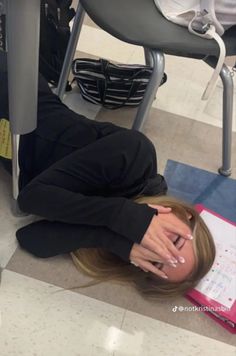 a woman laying on the floor with her head in her hands