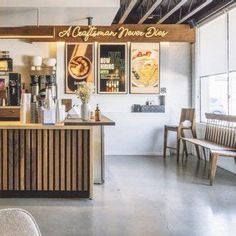 the interior of a restaurant with wooden tables and chairs, along with pictures on the wall