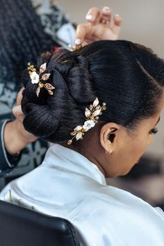 a woman is getting her hair done at the salon