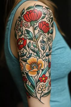 a woman's arm with flowers and leaves painted on the upper half of her arm