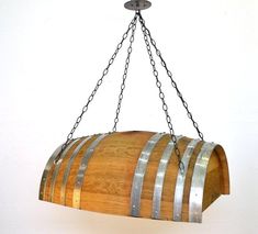 a wooden barrel hanging from a metal chain