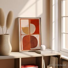 a vase with some flowers in it next to a painting on a shelf near a window