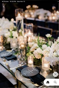 an image of a table setting with candles and flowers on the table for a wedding