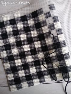 a pair of glasses sitting on top of a black and white checkered cloth