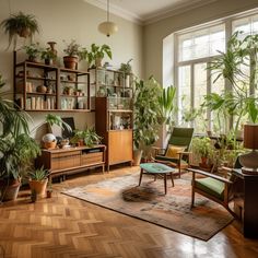 a living room filled with lots of plants and wooden furniture next to a large window