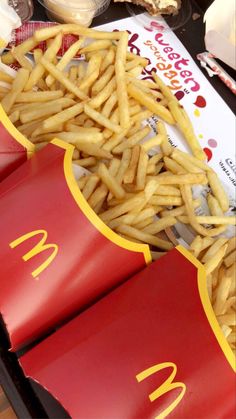 french fries are piled on top of mcdonald's hotdogs at a fast food restaurant