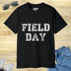 "Looking for a fun and exciting way to promote school spirit and teamwork? Look no further than our School Field Day design! Perfect for any school event or activity, this design is sure to get everyone in the spirit of friendly competition and camaraderie. With its bold colors and eye-catching design, our School Field Day graphic is the perfect way to show off your school pride and celebrate the power of teamwork. So why wait? Order your School Field Day design today and get ready to take your Collegiate Letter Print T-shirt For School, Casual T-shirt For School Football Season, Casual School T-shirt For Football Season, School Spirit Letter Print Tops For College Events, Casual Tops For School Football Season, Team Name T-shirt For School Sports Season, College Football Season Letter Print T-shirt, School Spirit T-shirt For Sports Season, School Spirit T-shirt With Letter Print For College Events