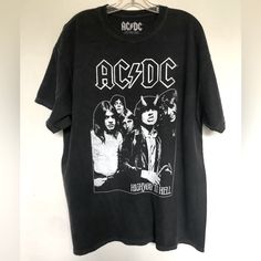 Ac/Dc Band Tee Featuring A Front Ac/Dc Graphic Above An Image Of The Band, World Tour 1979 Concert , 100% Cotton , Crew Neck, Short Sleeve T Shirt New 1x Chest 24.5” Length 30” Ac/Dc Highway To Hell Graphic T Shirt Black Band Logo Crew Neck Top, Black Crew Neck Tops With Band Logo, Black Crew Neck Top With Band Logo, Black Short Sleeve Tops With Band Logo, Black Short Sleeve Top With Band Logo, Black Band Logo Shirt For Summer, Retro Black Top With Band Logo, Black Shirt With Band Logo For Summer, Black Summer Shirt With Band Logo