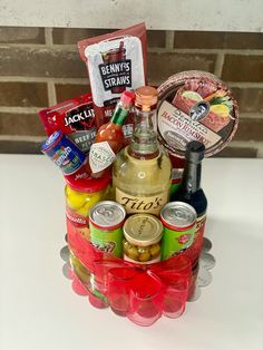 a basket filled with alcohol and snacks on top of a table