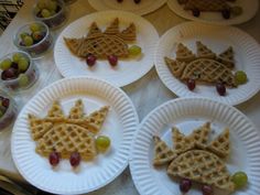 four paper plates with waffles and grapes on them