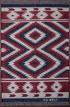 a red, white and blue rug with fringes on the bottom is sitting on a wooden floor