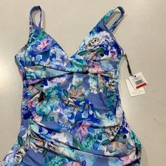 Nwt $88 Blue Chateau Floral Print. 4-Way Stretch. Twist Detail At Neckline. Tummy Control. Removable Soft Cups. Adjustable Straps. Lined. Hits At The Waist. Sleeveless Spring Tankini For Pool, Blue Sleeveless Tankini For Poolside, Blue Swim Dress With Built-in Bra For Summer, Blue Fitted Tankini For Beachwear, Fitted Blue Tankini For Beachwear, Fitted Blue Tankini Beachwear, Calvin Klein Blue Swimwear For Summer, Sleeveless Ruched Swimwear For Vacation, Blue Floral Print Tankini For Spring