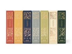 six books lined up on top of each other in different colors and designs, all with gold lettering