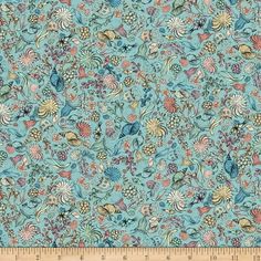 a blue fabric with flowers and leaves on it, as well as a measuring ruler