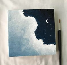 a painting with clouds and a half moon in the sky, on top of a white sheet