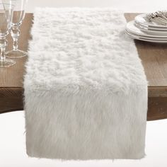 Take a detour from traditional decorating with this plush Faux Fur Table Runner, which adds beautiful warmth and texture to your tabletop. It will instantly elevate your table setting, giving it a glamorous-chic edge. Pair with metallic tableware for a contrasting effect between warm and cold, or simple, white dinnerware for a wintery look. Faux Fur Table Runner, Easter Dollar Tree Diy, Fur Table Runner, Fur Table, White Table Cover, Fur Design, White Dinnerware, Farmhouse Holiday, Easter Decorations Dollar Store