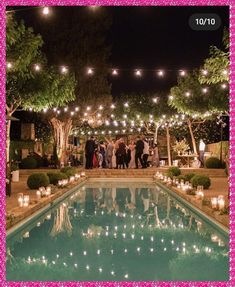 an outdoor pool with candles and lights around it