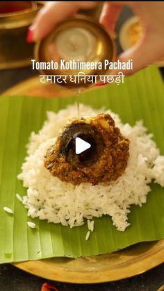 a plate with rice and meat on it, in the middle of a video about how to make tomatio kothimera pachadi