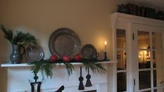 a white fireplace with christmas decorations on top